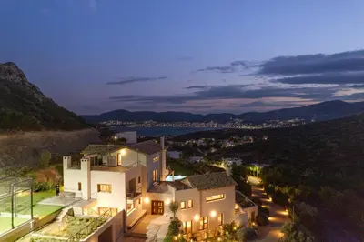 a villa with a view at night at Villa Lithos in Porto Rafti