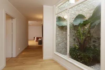 a hallway with a large window with a plant in it at Villa Lithos in Porto Rafti