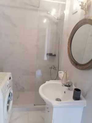a white bathroom with a sink and a mirror at Roof Top appartement with huge Terrace in Athens