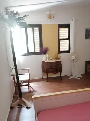 a living room with a desk and a palm tree at Roof Top appartement with huge Terrace in Athens