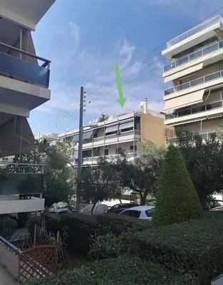 a view of a parking lot with a building at Roof Top appartement with huge Terrace in Athens