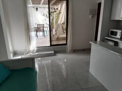 a kitchen with a view of a table with a microwave at Roof Top appartement with huge Terrace in Athens