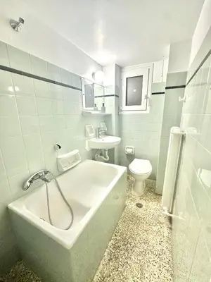 a bathroom with a tub and a sink and a toilet at Modern stay-10 mins from the city center- 5 mins from the beach in Athens