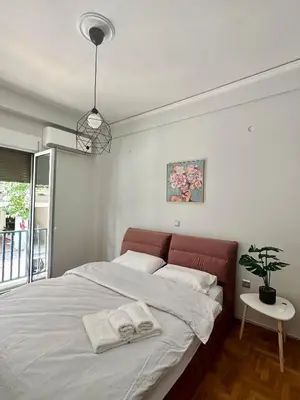 a bedroom with a large bed with towels on it at Modern stay-10 mins from the city center- 5 mins from the beach in Athens