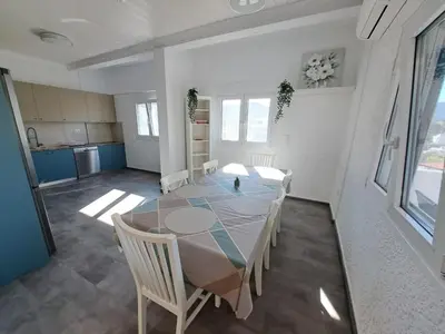 a dining room with a table and chairs at Daskalio Waves Appartment Filias in Dhaskalión