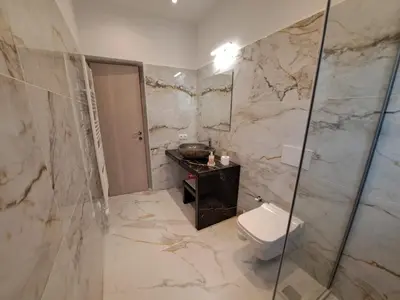 a bathroom with a toilet and a glass shower at Daskalio Waves Appartment Filias in Dhaskalión