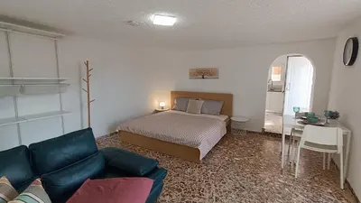 a bedroom with a bed and a table and a couch at Daskalio Waves Appartment Agapi in Dhaskalión