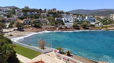 an aerial view of a beach with houses and a pool at Daskalio Waves Appartment Agapi in Dhaskalión