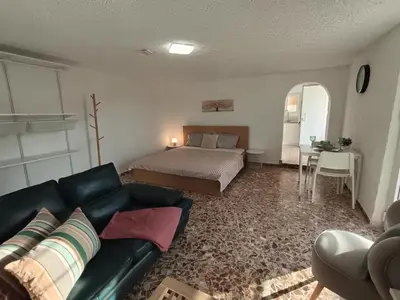 a living room with a couch and a bed at Daskalio Waves Appartment Agapi in Dhaskalión