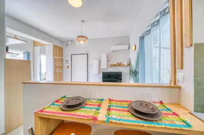 a dining room with a table with plates on it at Acropolis View Studio Varnava in Athens