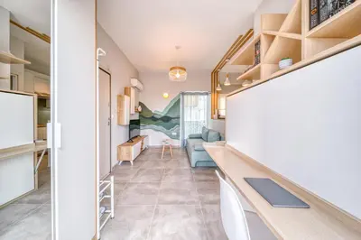 a kitchen and living room with a desk and a couch at Acropolis View Studio Varnava in Athens