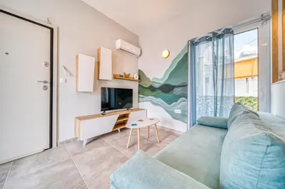 a living room with a couch and a tv at Acropolis View Studio Varnava in Athens