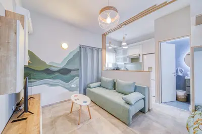 a living room with a couch and a tv at Acropolis View Studio Varnava in Athens