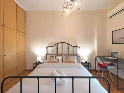 a bedroom with a bed and a desk at Kalliannassa in Piraeus