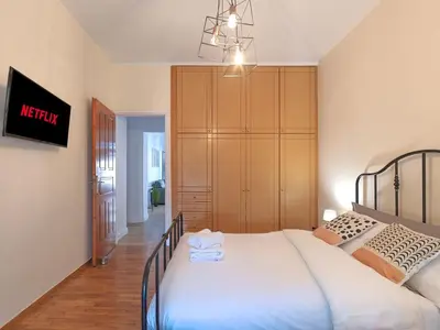 a bedroom with a large bed and a closet at Kalliannassa in Piraeus