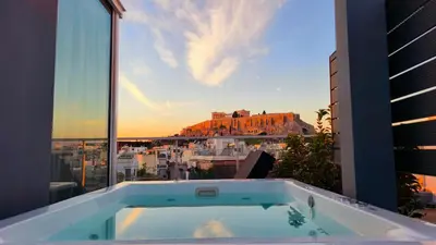 a bath tub with a view of a city at Penthouse Studio Acropolis View in Athens