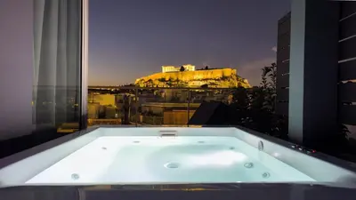 a bath tub with a view of the eiffel tower at Penthouse Studio Acropolis View in Athens