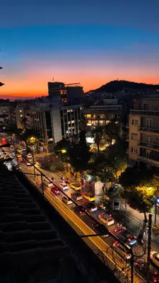 a city at night with traffic on a busy street at Penthouse Studio Acropolis View in Athens