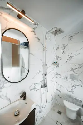 a white bathroom with a mirror and a sink at Penthouse Studio Acropolis View in Athens