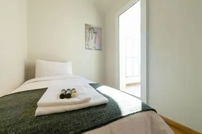 a bedroom with a bed with a pair of shoes on it at Spacious Central Apartment Close to Metro in Athens
