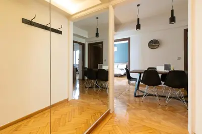 a mirror in a dining room with a table and chairs at Spacious Central Apartment Close to Metro in Athens