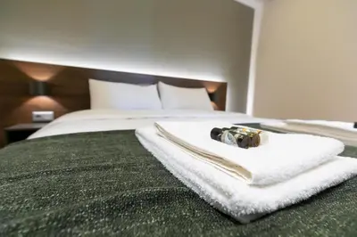 a hotel room with a bed with a towel on it at Spacious Central Apartment Close to Metro in Athens