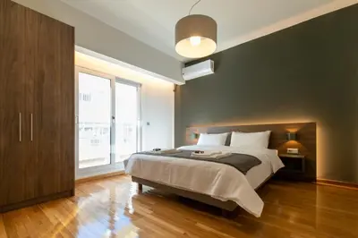 a bedroom with a large bed and a large window at Spacious Central Apartment Close to Metro in Athens