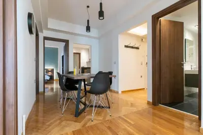 a kitchen and dining room with a table and chairs at Spacious Central Apartment Close to Metro in Athens