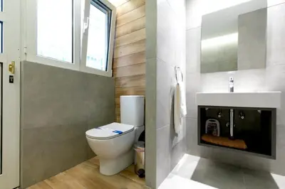 a bathroom with a toilet and a sink at Spacious Central Apartment Close to Metro in Athens