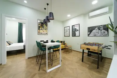 a room with a table and chairs and a bed at 2 BR Apartment with Sitcom Vibes VIPGreece in Athens