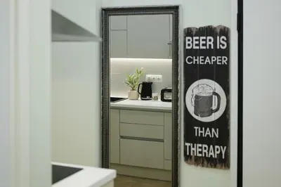 a mirror in a bathroom with a beer is cheaper than therapy at 2 BR Apartment with Sitcom Vibes VIPGreece in Athens