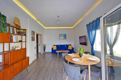 a living room with a table and a couch at The North - Floor apartment in Kato Halandri in Athens