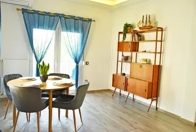 a dining room with a table and chairs at The North - Floor apartment in Kato Halandri in Athens