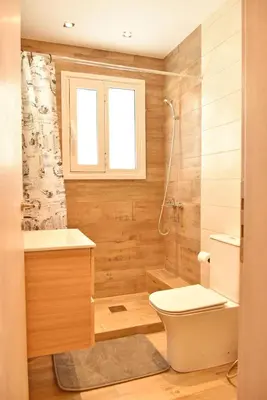a bathroom with a toilet and a sink and a shower at The North - Floor apartment in Kato Halandri in Athens