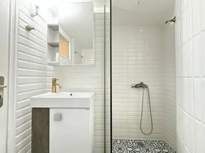 a white bathroom with a sink and a shower at Athenian Cosy Getaway 2 in Athens