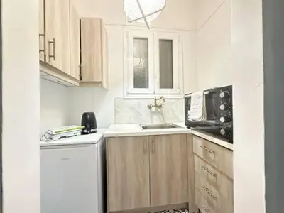 a small kitchen with a sink and a refrigerator at Athenian Cosy Getaway 2 in Athens