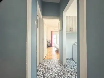 a hallway leading to a kitchen with a hallway at Athenian Cosy Getaway 2 in Athens