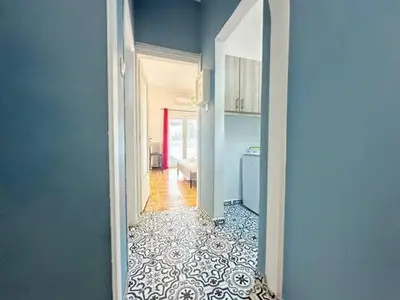 an open hallway with a kitchen and a room with a floor at Athenian Cosy Getaway 2 in Athens