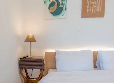 a bedroom with two beds and a lamp on a nightstand at Kolonaki Penthouse - Acropolis View - 5min Metro in Athens
