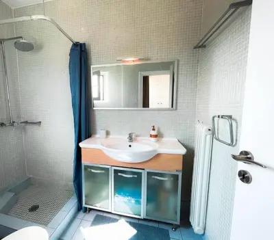 a bathroom with a sink and a shower at Kolonaki Penthouse - Acropolis View - 5min Metro in Athens