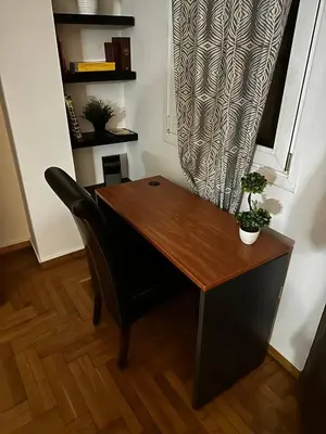 a wooden desk with a chair in a room at Kolonaki Penthouse - Acropolis View - 5min Metro in Athens