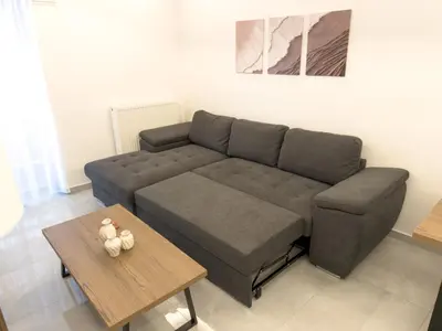 a living room with a couch and a coffee table at Alexandra's Apartment in Athens