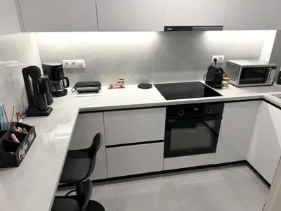 a kitchen with a stove and a microwave at Alexandra's Apartment in Athens