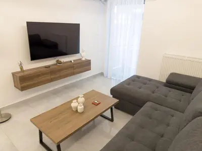 a living room with a couch and a coffee table at Alexandra's Apartment in Athens