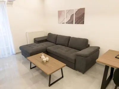 a living room with a couch and a table at Alexandra's Apartment in Athens