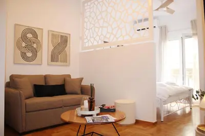 a living room with a couch and a table at ARIS Central Kypseli- Stylish Boho apartments in Athens