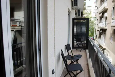 a balcony with two chairs and a table at ARIS Central Kypseli- Stylish Boho apartments in Athens