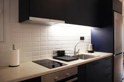 a kitchen with a sink and a stove top oven at ARIS Central Kypseli- Stylish Boho apartments in Athens