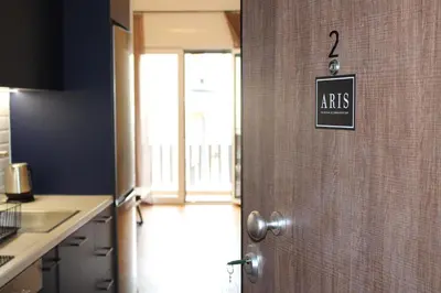 a door to a kitchen with a sign on the wall at ARIS Central Kypseli- Stylish Boho apartments in Athens