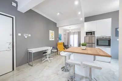 a kitchen and dining room with a table and chairs at 2 bedroom apt at Patisia metro station! in Athens